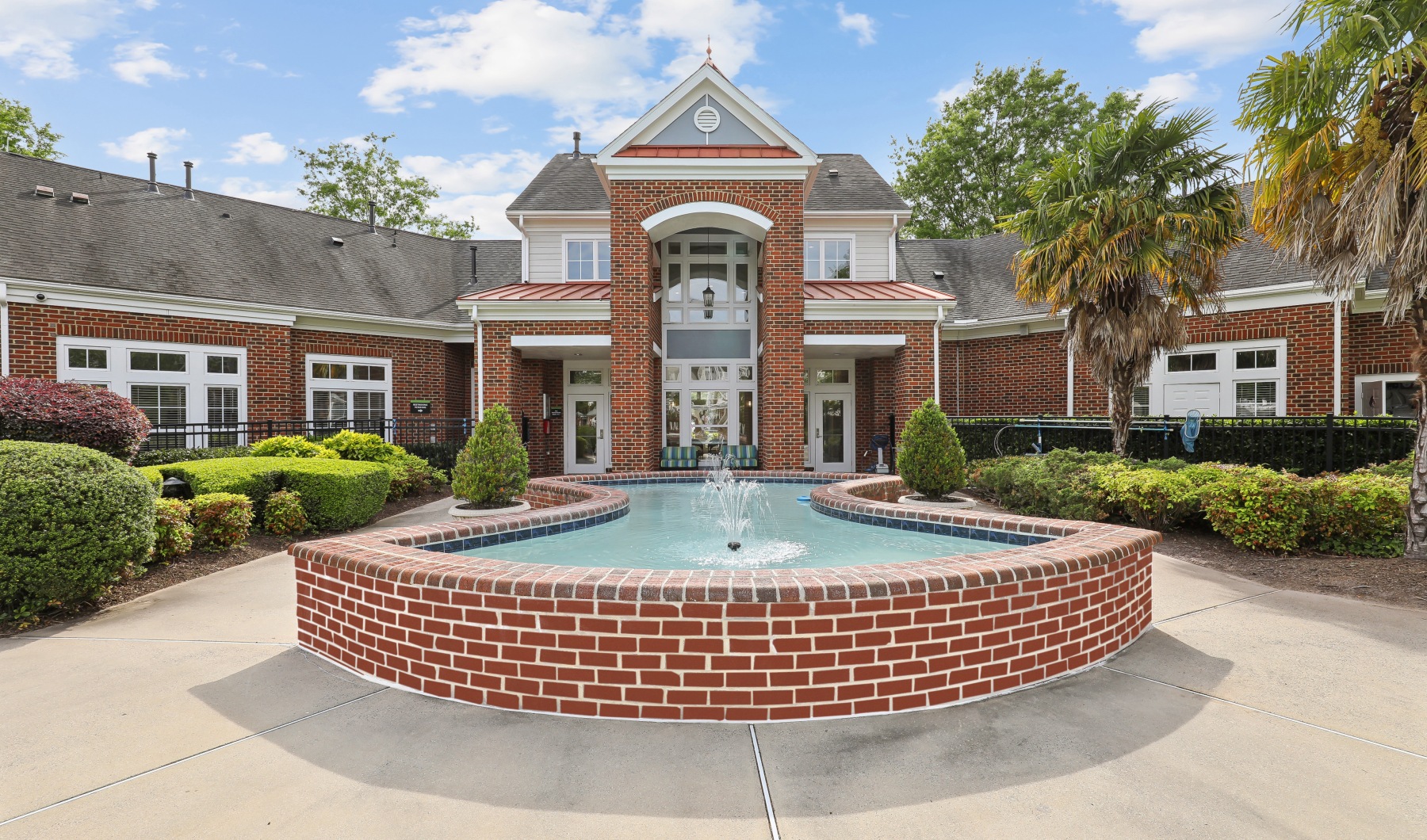 Discover the lifestyle you've always wanted at Banyan Grove apartments pool courtyard with fountain and amenity entrance