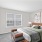 large windows in carpeted bedroom